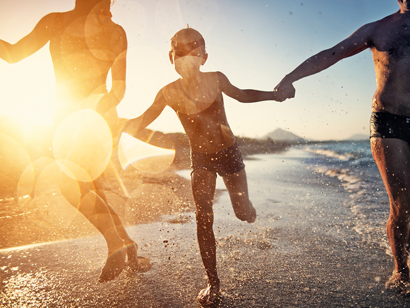 Family playing on the beach