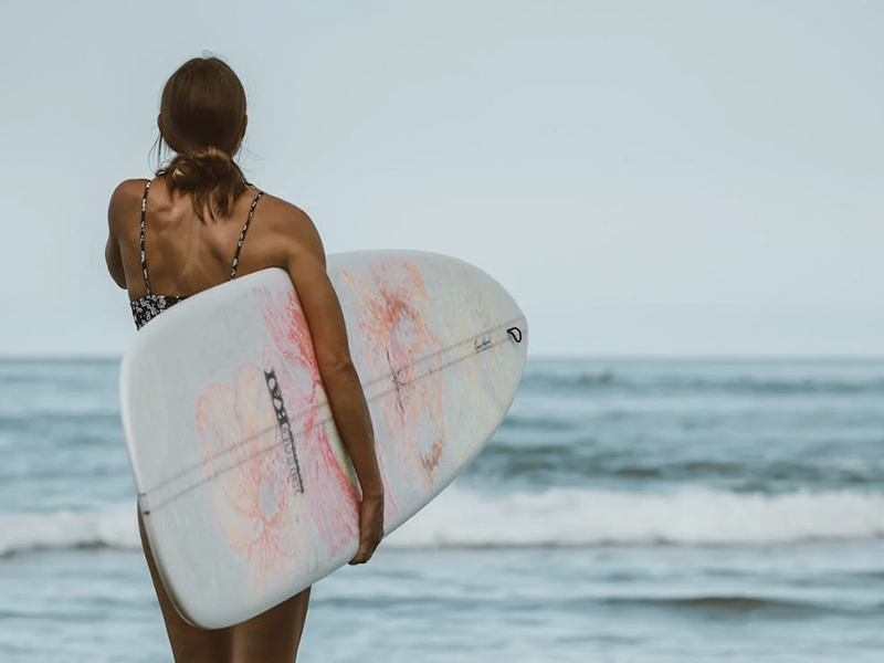 woman holding her surf board